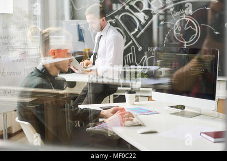 Busy young coder working with computer Stock Photo