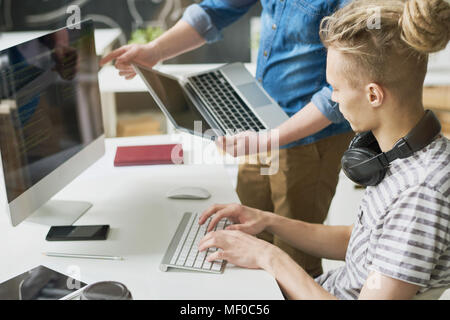 Colleagues coding information in office Stock Photo