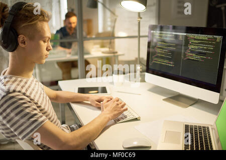 Confident software writer busy with new program Stock Photo