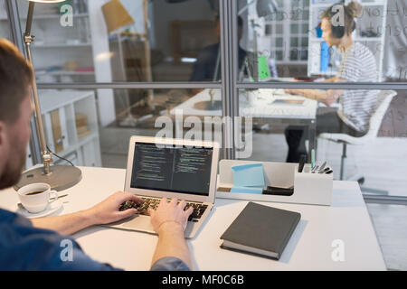 Coding on laptop Stock Photo