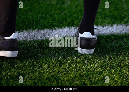foot of a soccer player or football player on green grass Stock Photo