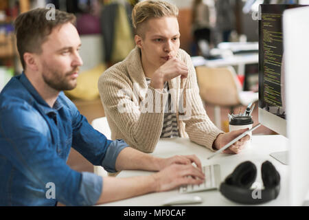 Pensive programmers working of software engineering project Stock Photo