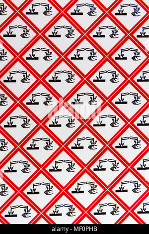 A sheet of the CLP Regulation/GHS chemical warning labels for Corrosive (Symbol: Corrosion) materials. Stock Photo