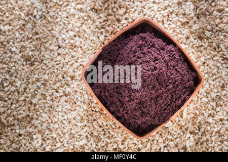 Acai powder in bowl on wooden background Stock Photo