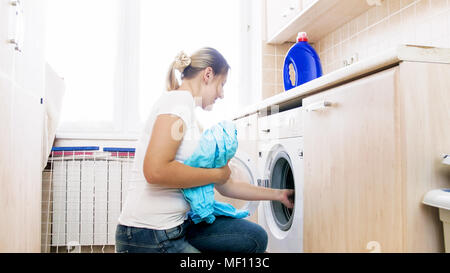 Young woman doing housework in laundry Stock Photo