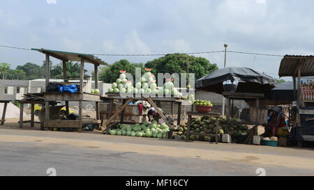 African women selling watermelons on market stalls on  the side of the road, Ivory Coast Stock Photo