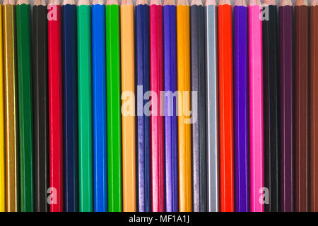 Colored pencils are placed in rows. Stock Photo