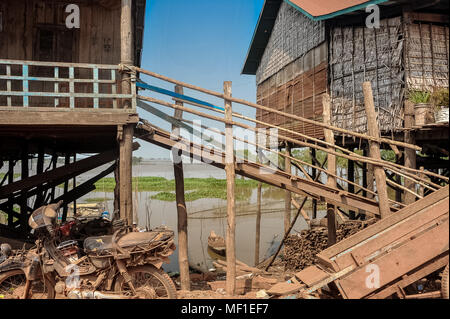 Typical stilt houses in Kampong Kleang fishing village, Tonle Sap Lake, Cambodia. Dust covered scene showing house construction detail Stock Photo