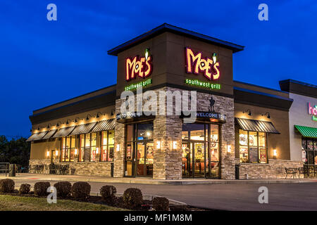 Utica, NY - DECEMBER 02, 2017: A Moe's Southwest Grill Restaurant Illuminated at Night. Moe's is A Fast Casual Dining Mexican Food Restaurant with ove Stock Photo