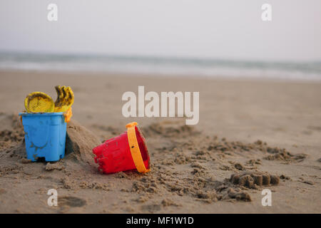 red and blue toy bucket for kid on sand beach Stock Photo