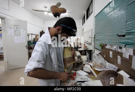 Gaza City, Gaza Strip, Palestinian Territory. 24th Apr, 2018. A Palestinian staff member prepares a prosthetic leg at Gaza's Artificial Limbs and Polio Center (ALPC) in Gaza City on April 24, 2018. According to Gaza health ministry, 17 Palestinians had limbs amputated during clashes with Israeli security forces in tents protest demanding the right to return to their homeland, at the Israel-Gaza border, after they failing to have access to sufficient medical care outside Gaza Strip Credit: Mahmoud Ajour/APA Images/ZUMA Wire/Alamy Live News