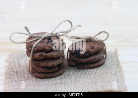 Chocolate chip cookies are tied in a row to gift on a wooden table Stock Photo