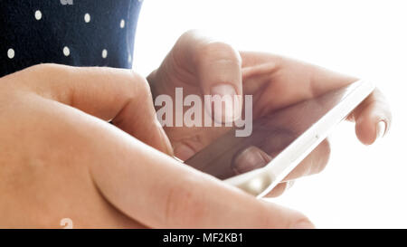 Isolated closeup photo of young woman browsing internet on mobile phone Stock Photo