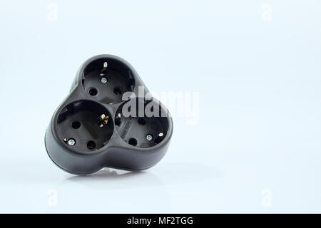 Isolated triple plug adapter on white background Stock Photo
