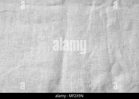 Crumpled linen fabric background. Black and white burlap canvas texture template for overlay artwork. Stock Photo