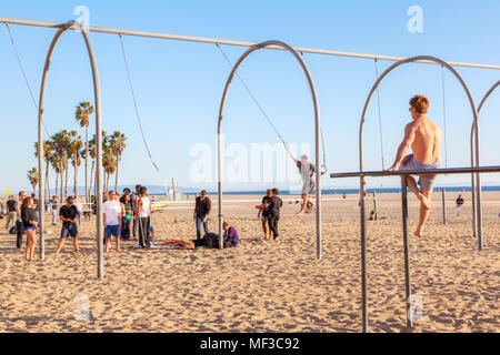 SANTA MONICA, USA - MAR 26, 2018: A crowd working out on the traveling rings and parallel bars at Santa Monica beach in California renowned as the bir Stock Photo