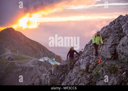 Austria, Tyrol, Innsbruck, mountaineer at Nordkette via ferrata at sunrise Stock Photo