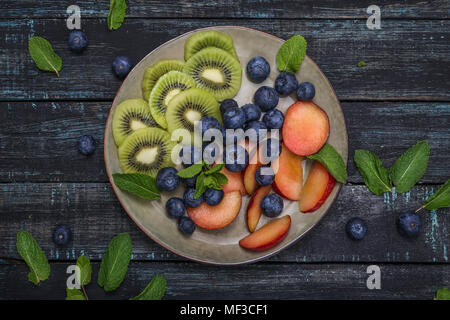 Plate with blueberries and slices of kiwi and nectarine Stock Photo