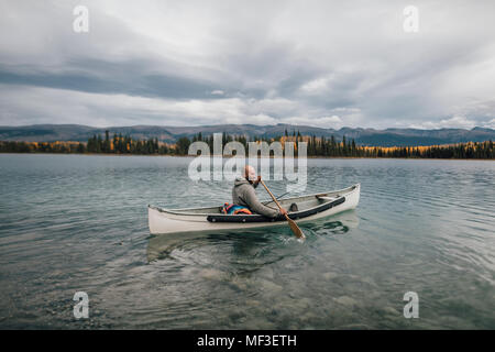 Canada, British Columbia, man in canoe on Boya Lake Stock Photo