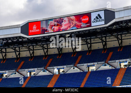 MADRID - APRIL 14, 2018: Emirates, Coca Cola, Adidas logos on the screen of the Santiago Bernabeu stadium, the home arean of the football club Real Ma Stock Photo