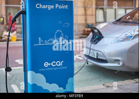 Electric car on charge using a street located charging point in Belfast city centre Stock Photo