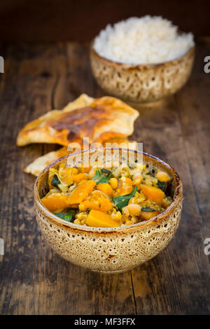 Curry dish with cauliflower, butternut pumpkin, spinach and coriander, papadam and rice Stock Photo