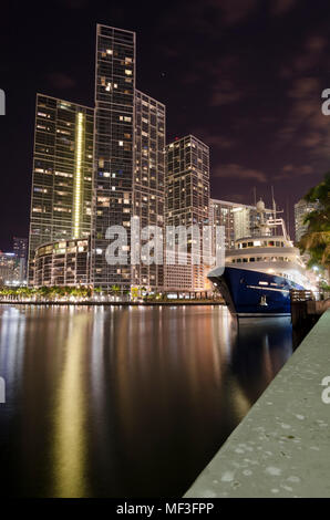 USA, Florida, Miami, High-rise buildings and luxury yacht at night Stock Photo
