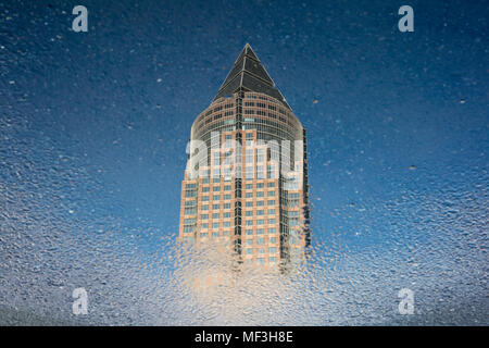 Germany, Hesse, Frankfurt, Trade Fair Tower, mirrored in puddle Stock Photo