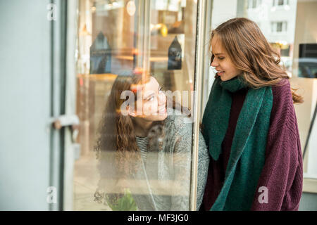 Two teenage girls at shop window Stock Photo
