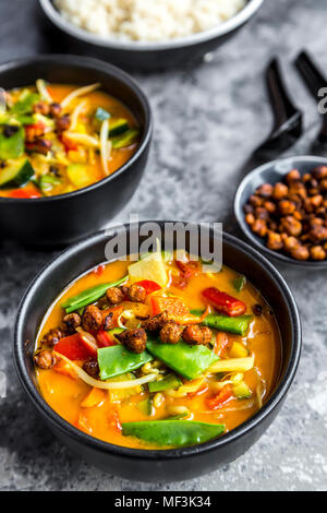 Red curry in bowls and roasted chickpeas Stock Photo