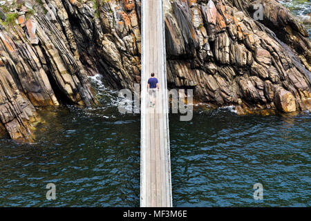 Africa, South Africa, Western Cape, Paarl, Garden Route National Park, Tsitsikamma National Park, man walking on wooden bridge