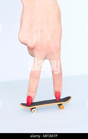 Close-up of woman's hand with fingerboard Stock Photo