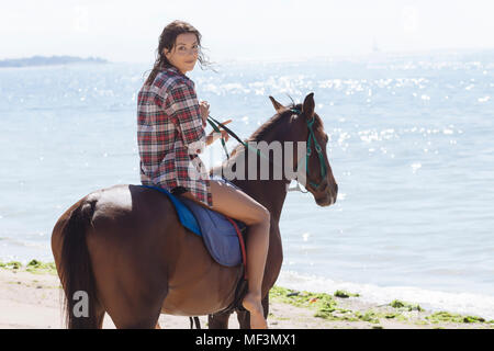 Indonesia, Bali, Woman riding a horse at beach Stock Photo - Alamy