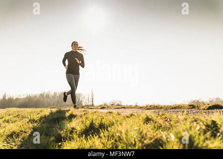 Young woman running on rural path