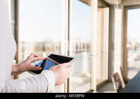 Close-up of businesswoman using tablet in office Stock Photo