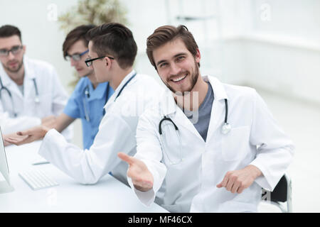 friendly doctor making a welcome gesture Stock Photo