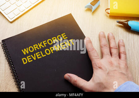 Book with title workforce development on a desk. Stock Photo