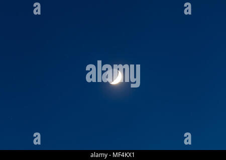 Moon - Waxing Crescent and grey light against blue starry sky background Stock Photo