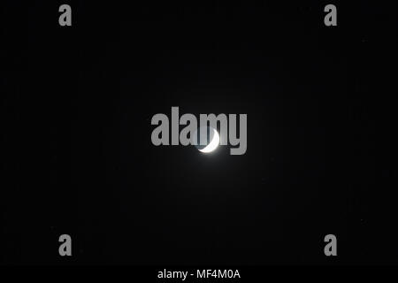 Moon - Waxing Crescent and grey light against dark starry sky background Stock Photo