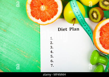 Food and sheet of paper with a diet plan on a wooden background. Concept of diet and healthy lifestyle. Stock Photo