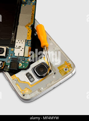 Broken cell phone  with small screwdriver on white background Stock Photo