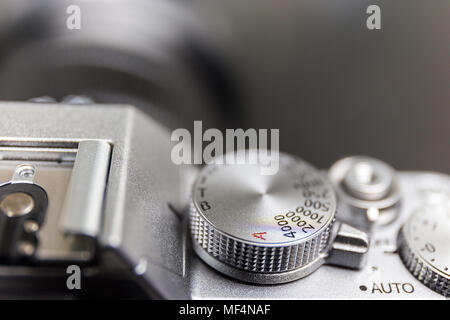 shutter speed and exposure control dial, button, on silver modern mirrorless camera Stock Photo