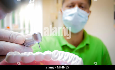 View from inside of the mouth of dentist drilling teeth Stock Photo