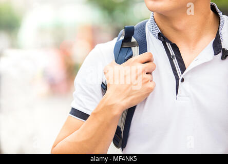 backpacker traveler hand handle sash of his backpack in travel location in many landmark alone Stock Photo