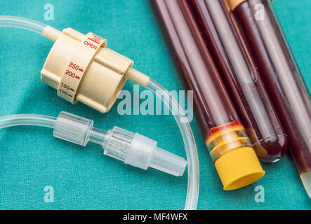 Dial flow regulator next to medicine bag in a hospital, conceptual image Stock Photo