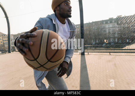 Basketball player in action on court Stock Photo