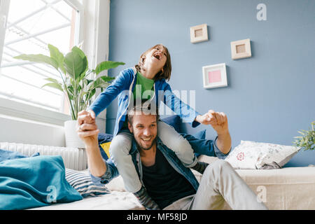 Happy father and son playing at home Stock Photo