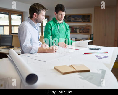 Architects working on construction drawing Stock Photo