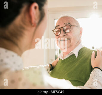 Senior man smiling at young woman Stock Photo