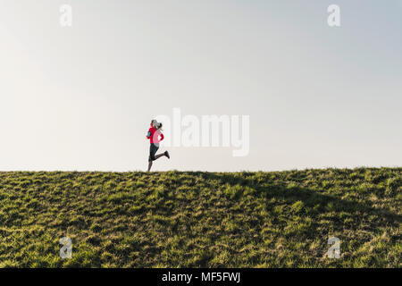 Young woman running on rural path Stock Photo